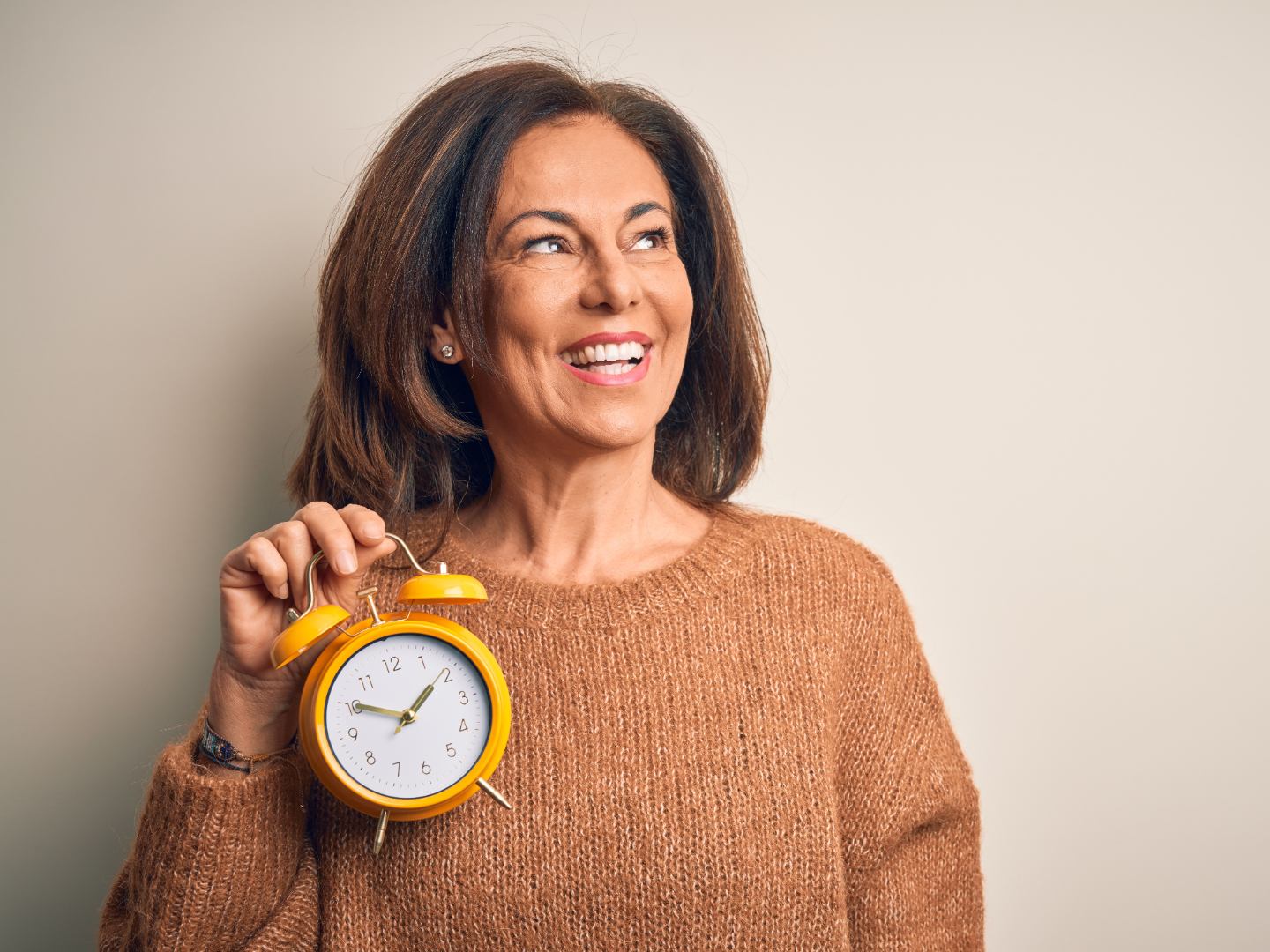 Woman holding an alarm clock